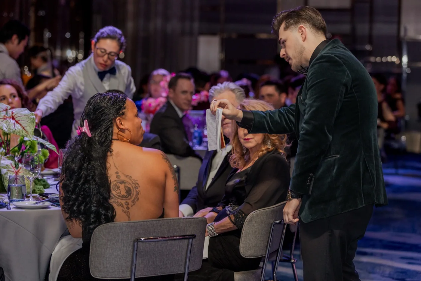 Wedding guests reacting at a reception table