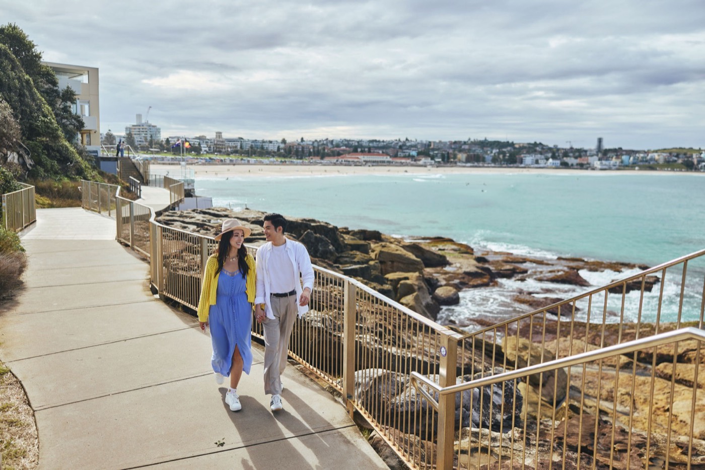 Walkers on the clifftop path of the Bondi to Coogee coastal walk with Bondi Beach behind