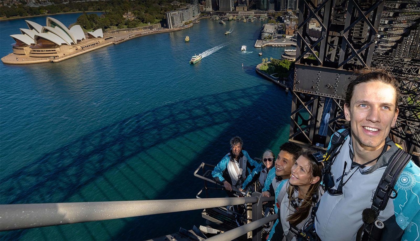 BridgeClimb climbers on the Harbour Bridge arch high above the harbour and Opera House