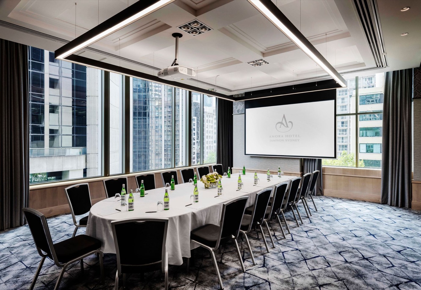 Lindsay Room at Amora Hotel Jamison set for a meeting with a projector screen