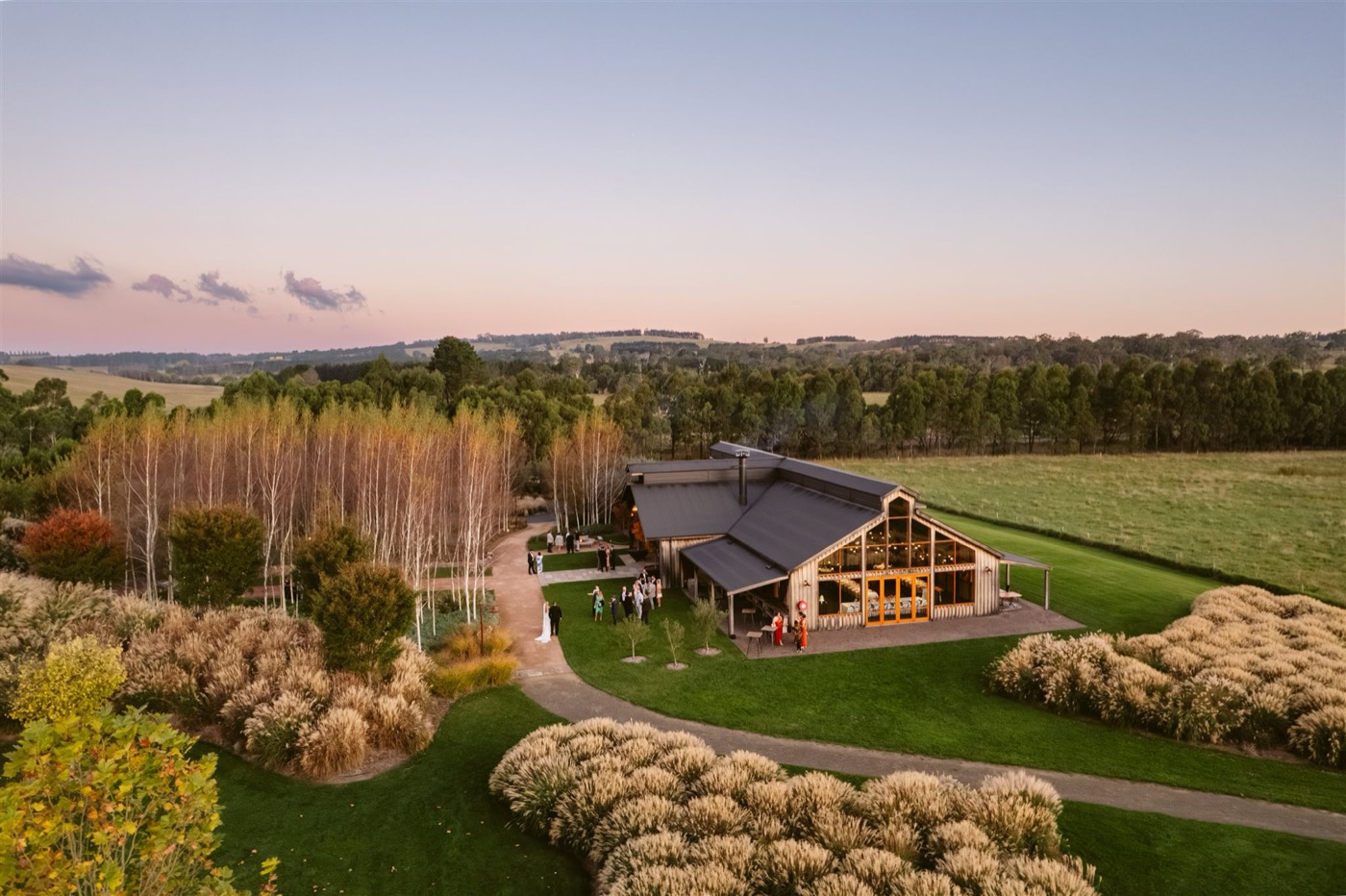 Aerial view of The Stables at Bendooley Estate among gardens and paddocks at dusk