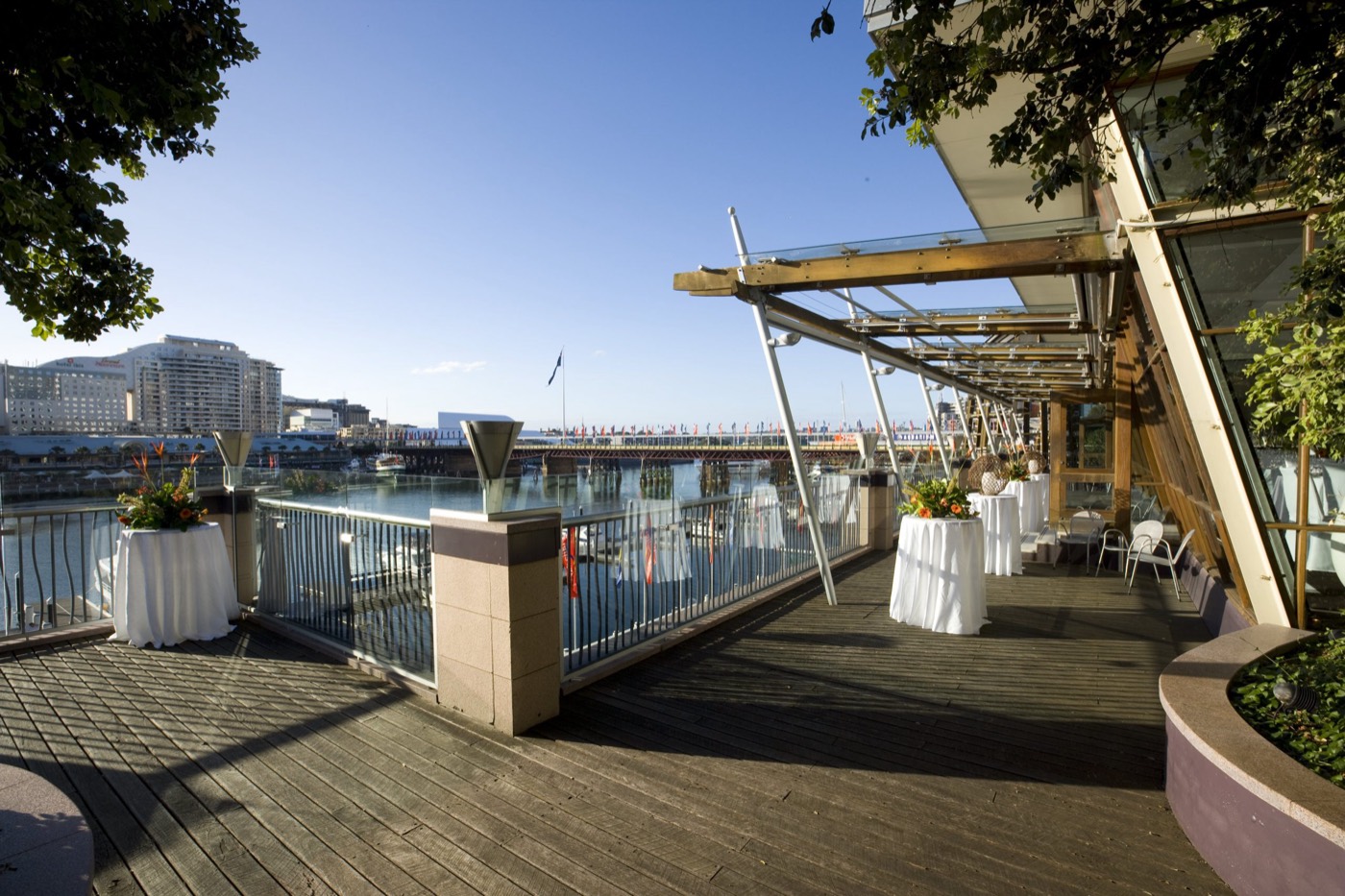 L'Aqua Terrace Room balcony at Dockside set for cocktails over Darling Harbour