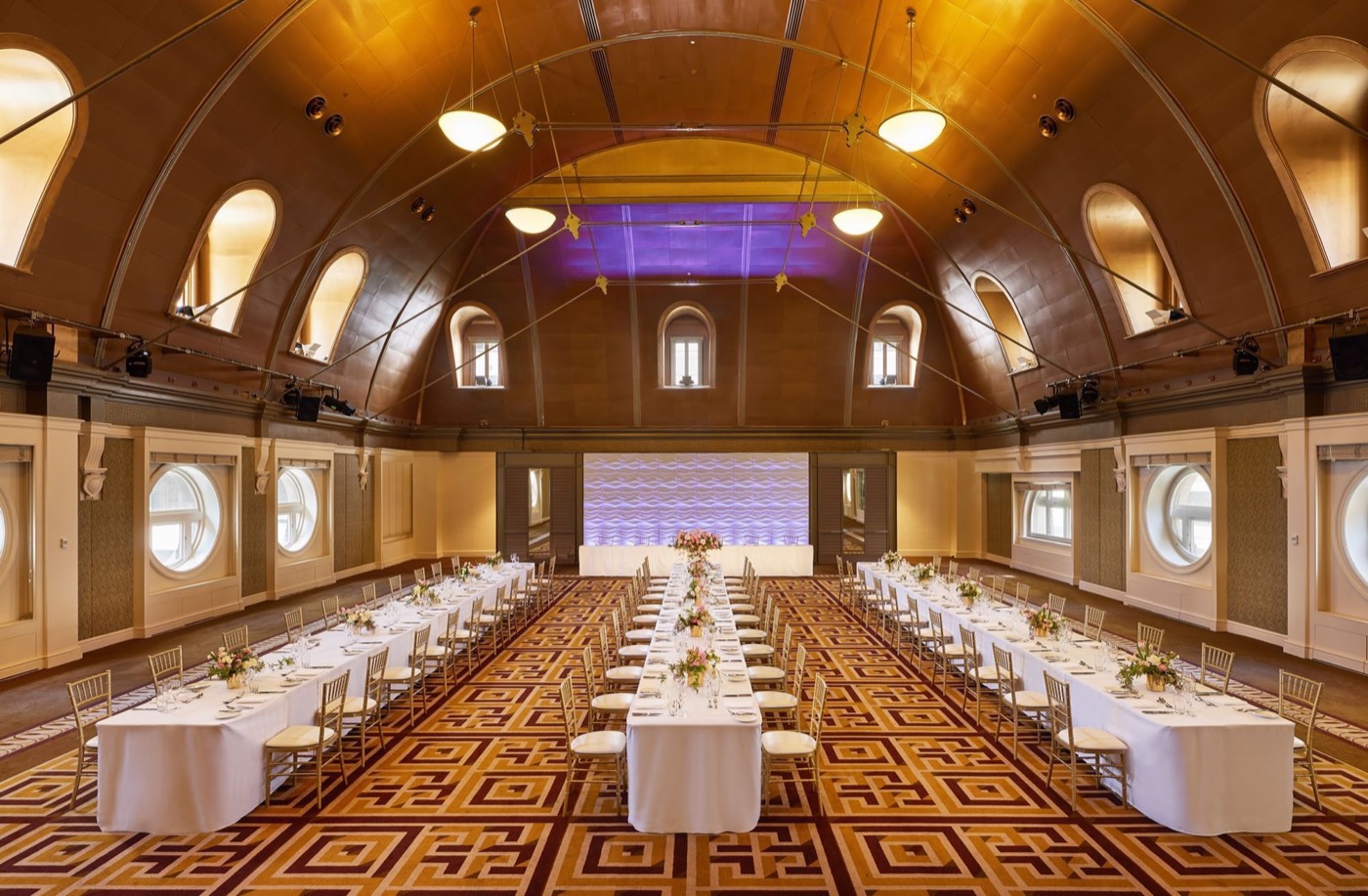 The Fullerton's vaulted Heritage Ballroom set with long dining tables