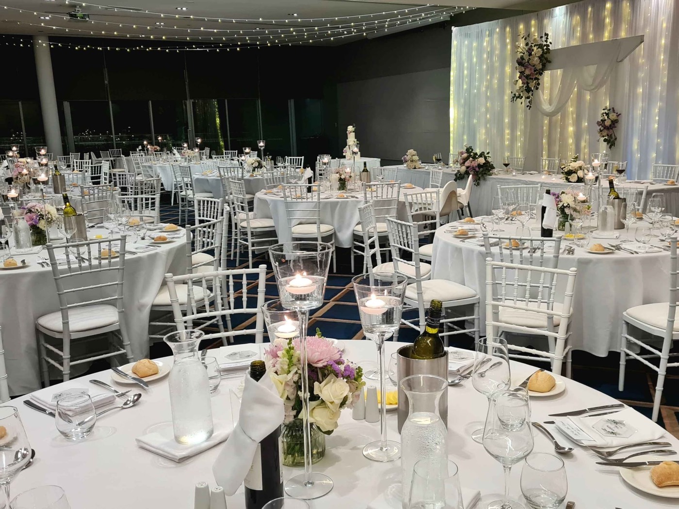 The Magenta Ballroom set for a banquet with fairy lights