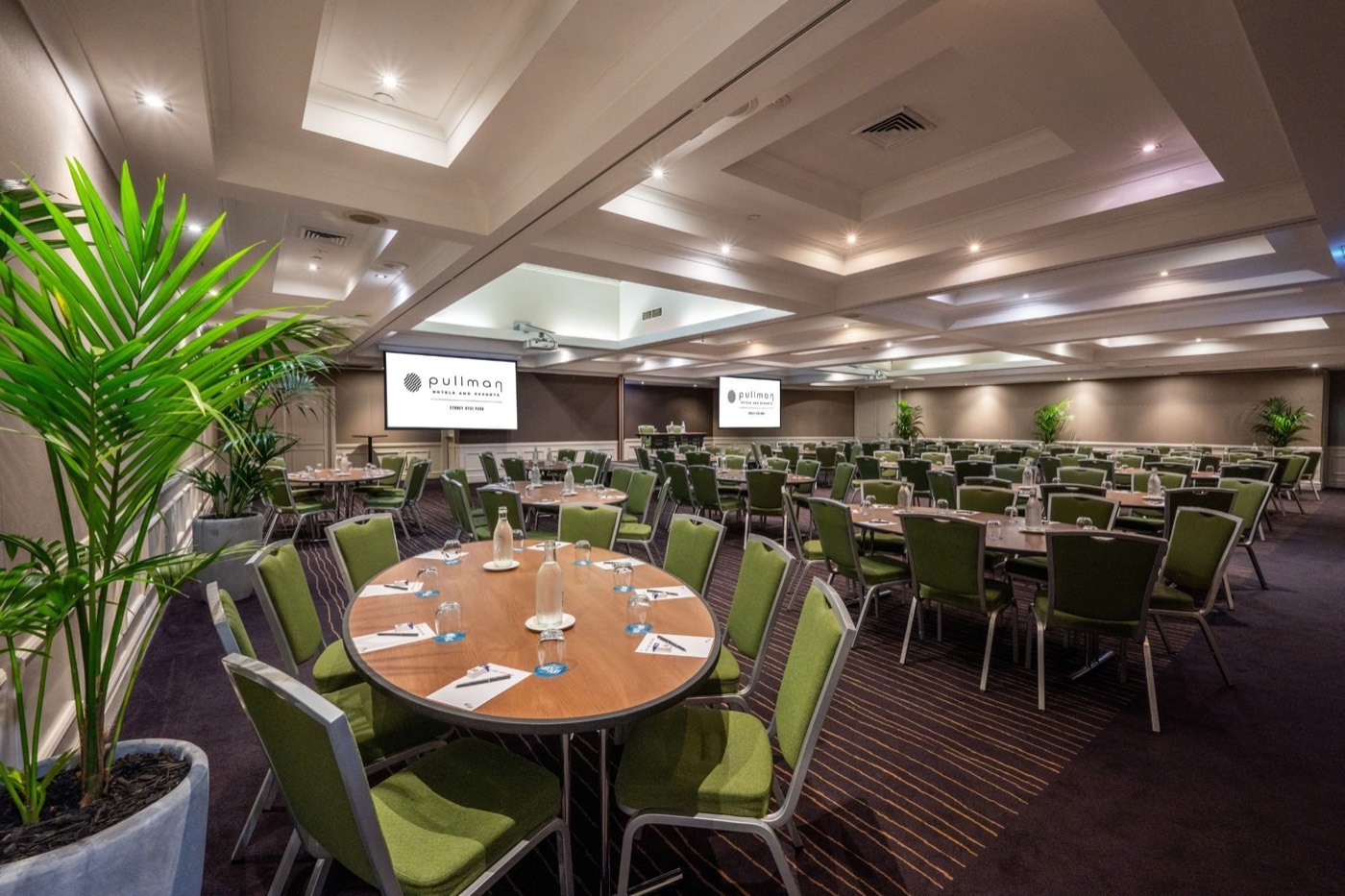Pullman Sydney Hyde Park function room set cabaret-style with green chairs