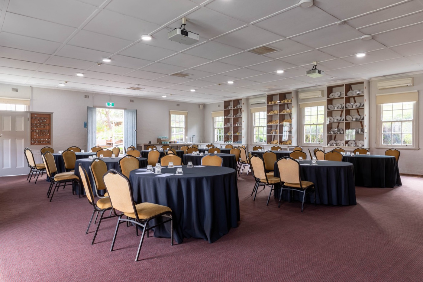 A Q Station heritage event room set with round tables