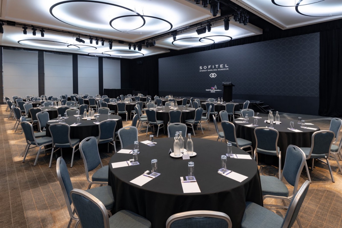 Magnifique Ballroom at Sofitel Sydney Darling Harbour set with round tables for a conference