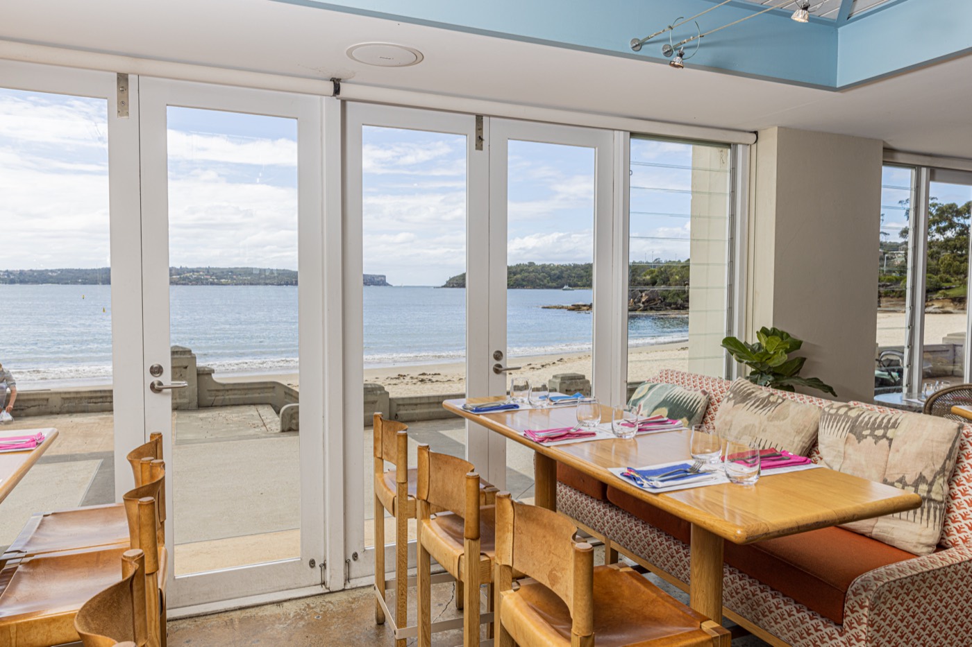 Bathers' Bistro dining room with doors open onto Balmoral Beach