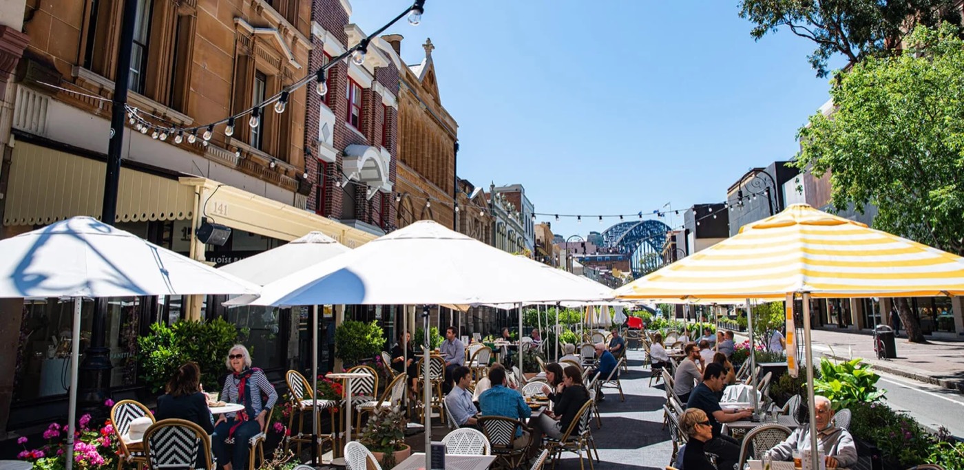 Umbrella-shaded outdoor tables along George Street outside the Fortune of War