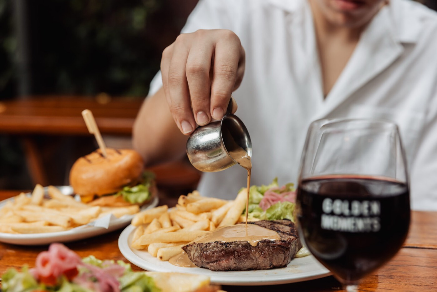 Steak, burger and red wine on a table at The Golden Sheaf