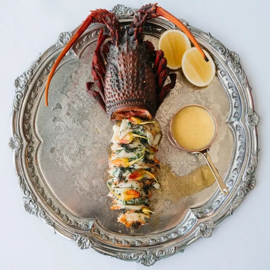 Grilled lobster served on a silver platter at Icebergs Dining Room and Bar