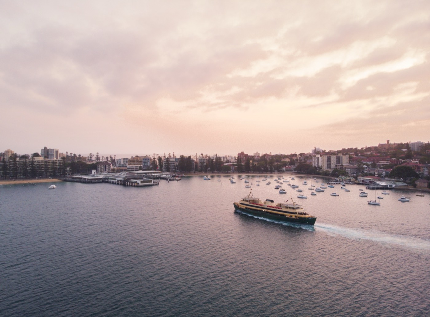 A Manly ferry arriving at Manly Cove at sunset