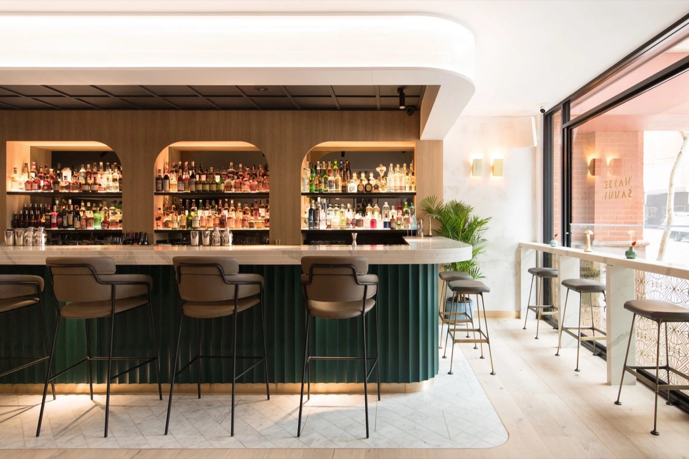 Green fluted bar and arched back-bar shelves at Maybe Sammy in The Rocks
