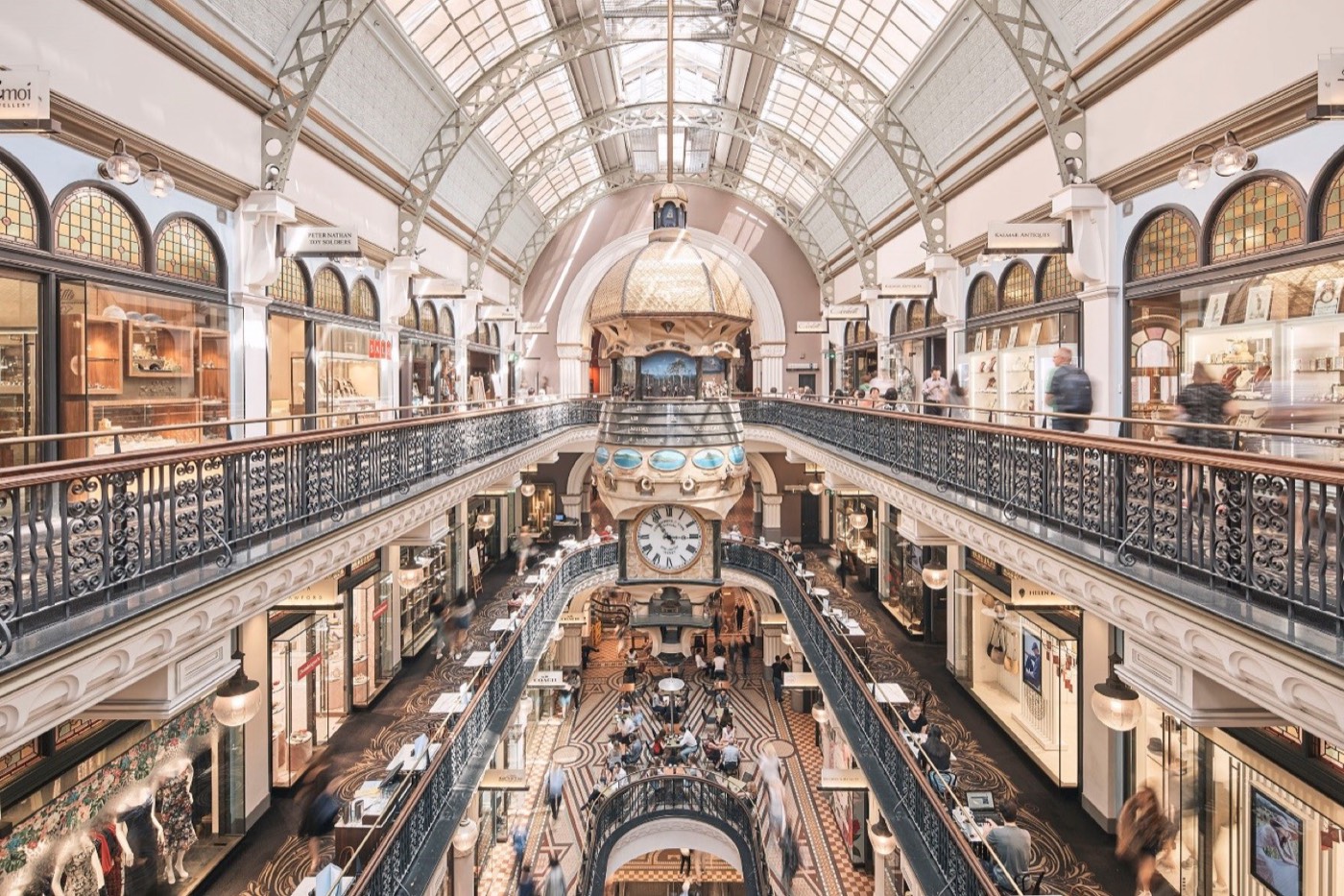 Interior of the Queen Victoria Building with its glass roof, balconies and hanging clock