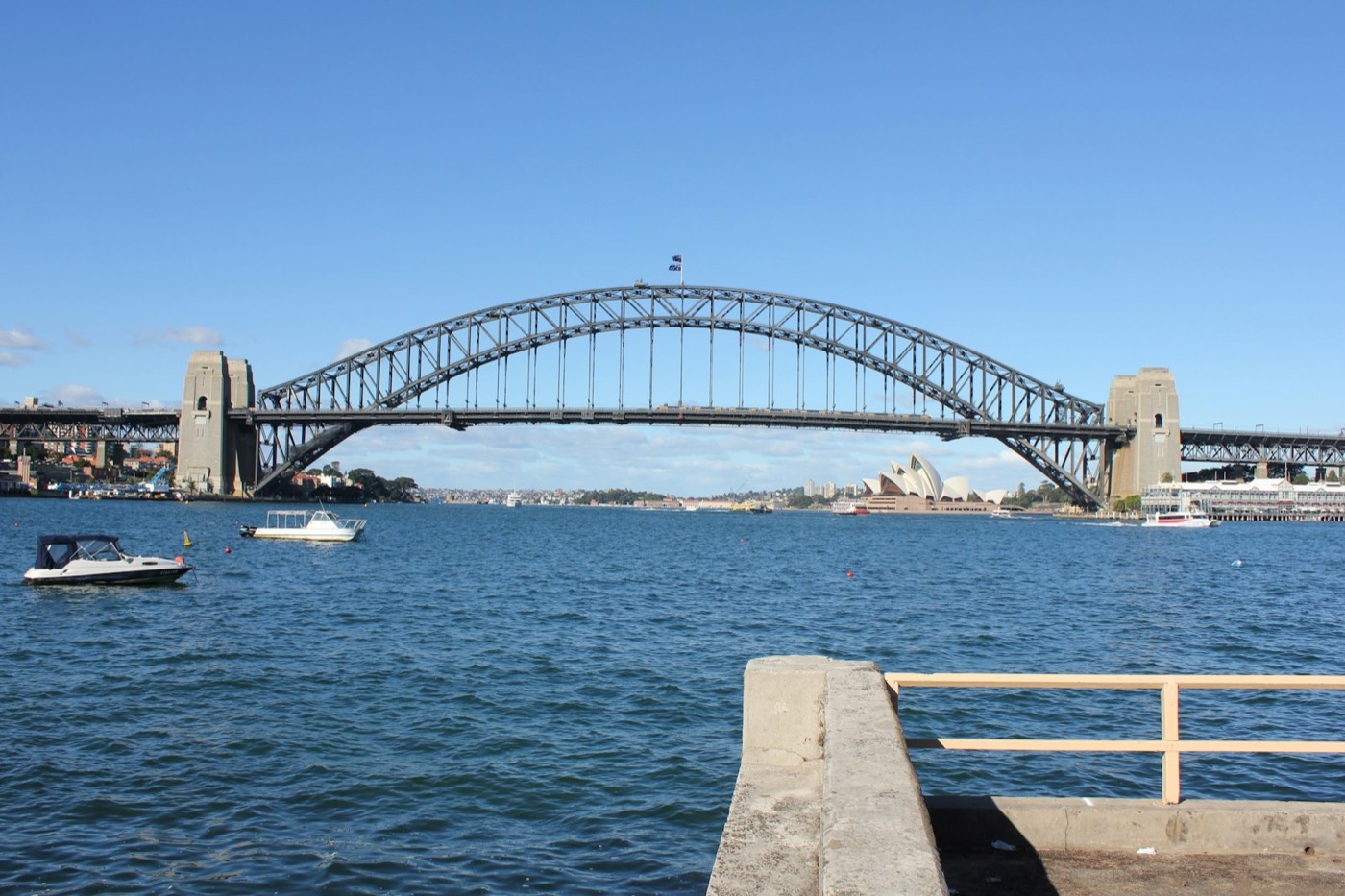 Sydney Harbour Bridge and Opera House seen across the water from the Blues Point Reserve jetty
