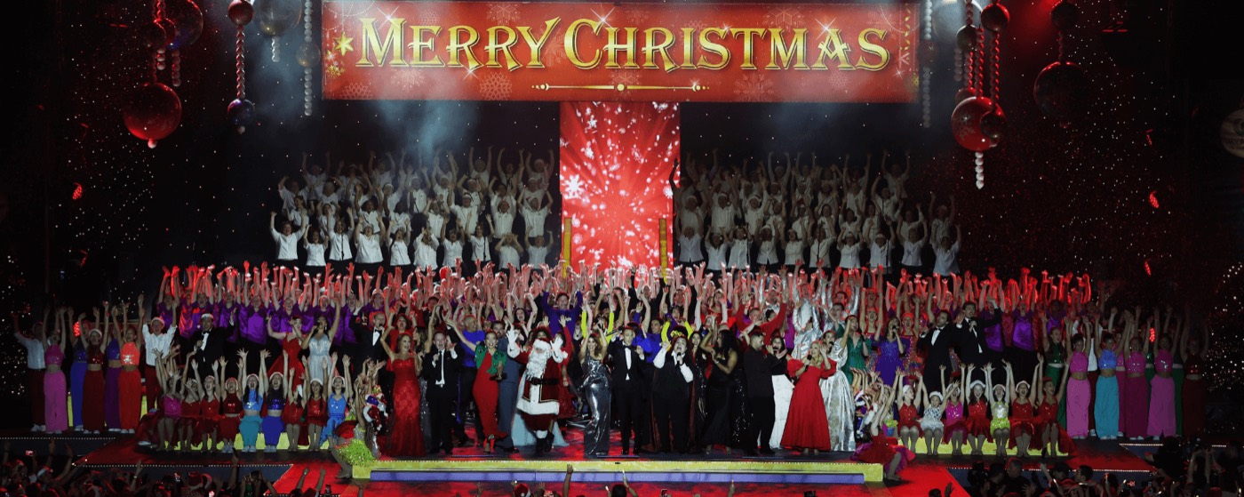 Massed choir and performers on the lit Carols in the Domain stage