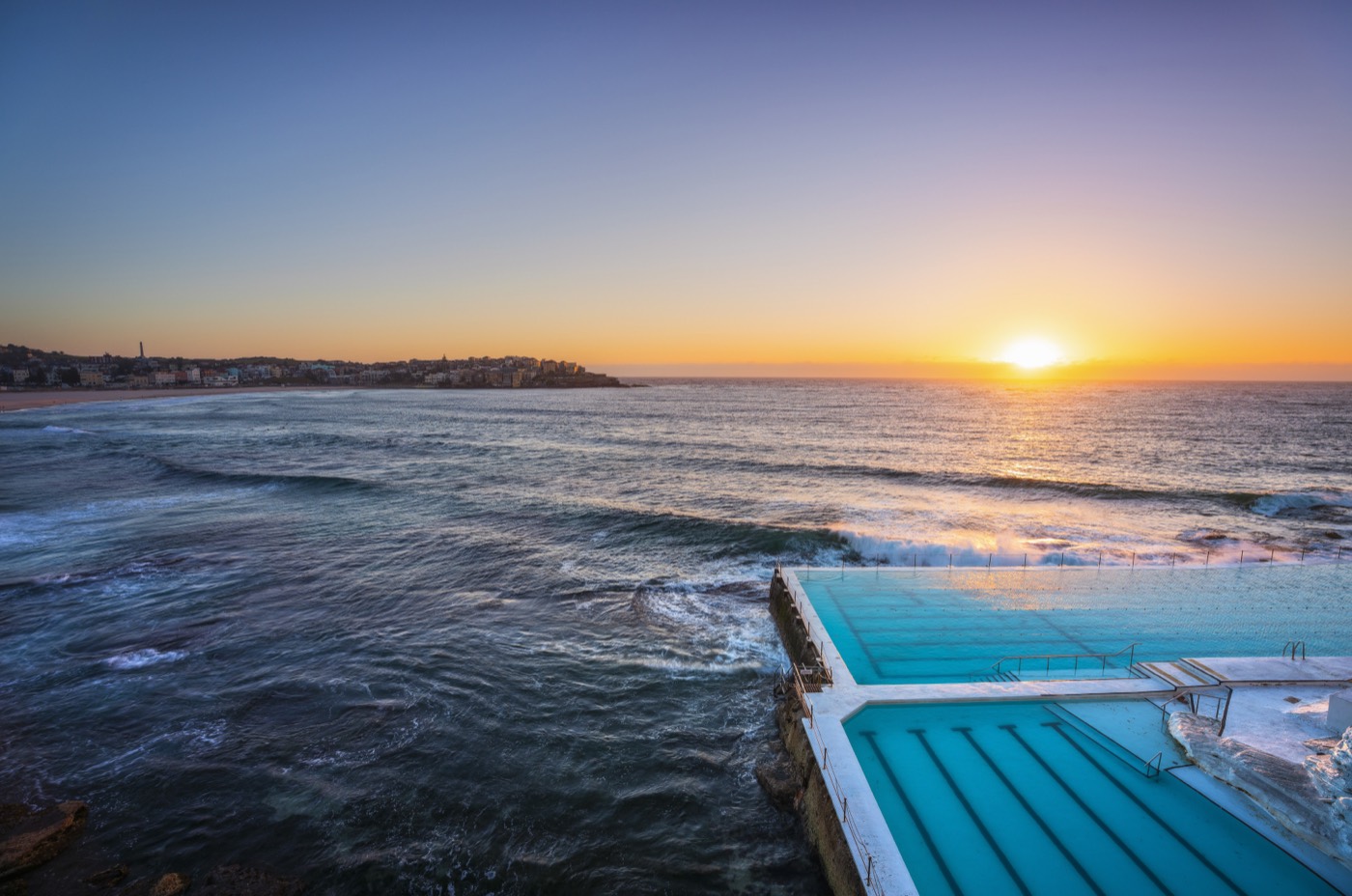 Sunrise over the ocean beside the Bondi Icebergs pool