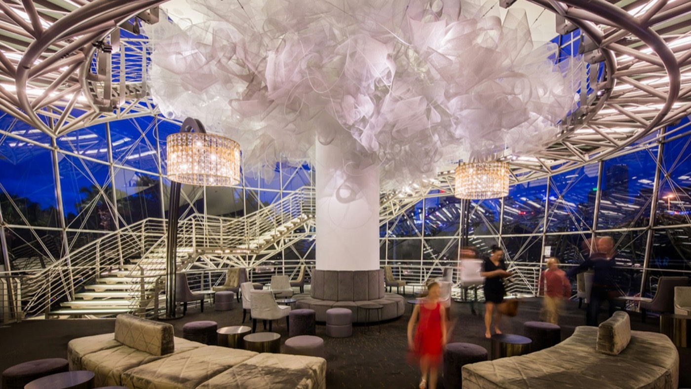 Glass-walled foyer of the Sydney Lyric with a large sculptural chandelier