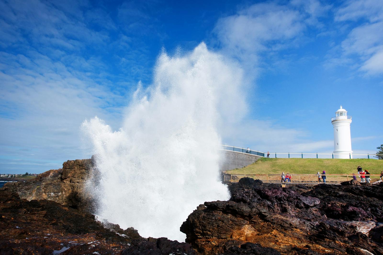 Kiama Blowhole erupting beside Kiama Lighthouse