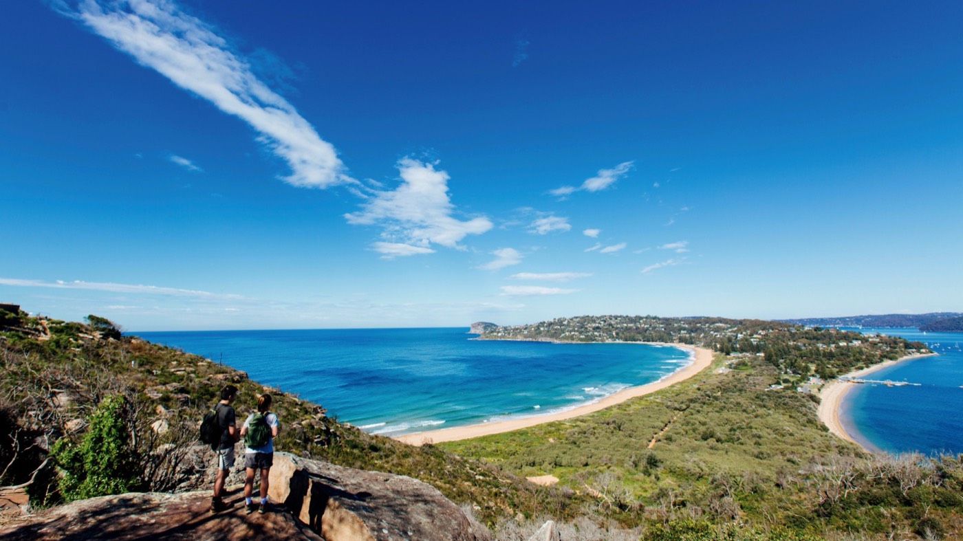 Walkers at Barrenjoey Headland looking south over Palm Beach and Pittwater