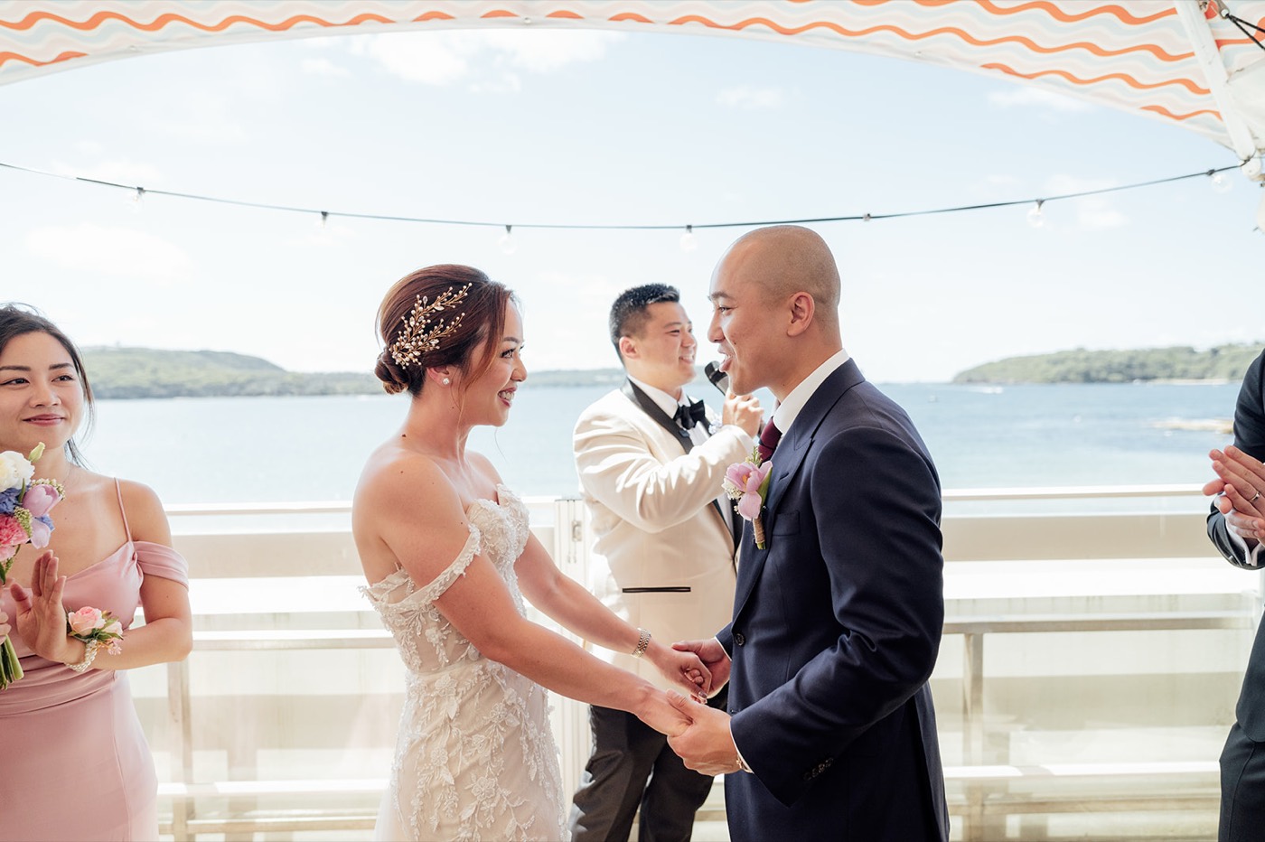 Couple exchanging vows on the Bathers' Pavilion terrace overlooking Balmoral Beach
